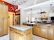 Open kitchen with wood cabinets, center island, stainless steel appliances, and easy access to the living area at 3001 Regal Oaks Blvd, Palm Harbor, FL 34684