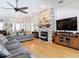 Cozy living room with a brick fireplace, modern furnishings, and access to the front entryway at 3001 Regal Oaks Blvd, Palm Harbor, FL 34684