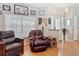 Comfortable living room with a leather recliner, hardwood floors, and a view of the front door at 3001 Regal Oaks Blvd, Palm Harbor, FL 34684