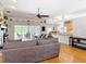 Open-concept layout with a view of the living room, kitchen, and screened-in pool area at 3001 Regal Oaks Blvd, Palm Harbor, FL 34684
