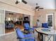 Covered outdoor patio with a fire pit table, comfortable seating, and sliding glass doors to the living room at 3001 Regal Oaks Blvd, Palm Harbor, FL 34684