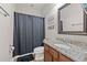 Charming bathroom with a shower and tub combination, stylish vanity with granite countertop, and decorative accents at 32122 Wenlock Loop, Wesley Chapel, FL 33543