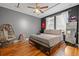 Cozy bedroom with hardwood floors, neutral walls, plenty of natural light, and unique decorations at 32122 Wenlock Loop, Wesley Chapel, FL 33543