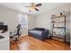 Comfortable bedroom with wood floors, natural light, computer desk, and unique decor at 32122 Wenlock Loop, Wesley Chapel, FL 33543