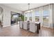 Bright dining room with wood floors, large windows, stylish lighting, and easy access to the outdoor lanai at 32122 Wenlock Loop, Wesley Chapel, FL 33543