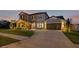 Stunning two-story home featuring a manicured lawn, stone accents and a spacious three-car garage at 32122 Wenlock Loop, Wesley Chapel, FL 33543