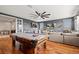 Entertaining game room featuring pool table, TV, ceiling fan, and comfortable seating to enjoy Gathering time at 32122 Wenlock Loop, Wesley Chapel, FL 33543