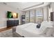 Spacious bedroom with a large window view, light gray walls, with a comfortable upholstered bench at the foot of the bed at 32122 Wenlock Loop, Wesley Chapel, FL 33543