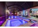 Enclosed pool area boasts a large pool, spa, waterfall, lounge chairs, and poolside TV at 32122 Wenlock Loop, Wesley Chapel, FL 33543