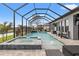 Sparkling screened pool with a built-in spa, a soothing waterfall feature, and ample space for relaxation at 32122 Wenlock Loop, Wesley Chapel, FL 33543