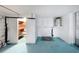 Unfinished basement with painted floor, shelving, and a water heater at 3243 Eisenhower Dr, Holiday, FL 34691