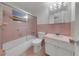 Retro bathroom with a shower-tub combination and vanity at 3243 Eisenhower Dr, Holiday, FL 34691