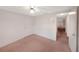 Bedroom with ceiling fan, door, and hallway view at 3243 Eisenhower Dr, Holiday, FL 34691