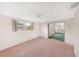 Bedroom with a window and sliding glass doors leading to a lanai at 3243 Eisenhower Dr, Holiday, FL 34691