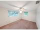 Bedroom featuring windows for natural light and a ceiling fan for comfort at 3243 Eisenhower Dr, Holiday, FL 34691