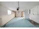 A spacious garage with painted floor, white cabinets, and garage door at 3243 Eisenhower Dr, Holiday, FL 34691