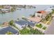 Aerial view showcasing waterfront living with a private dock, lush greenery, and neighborhood waterways at 330 Palm Ne Is, Clearwater Beach, FL 33767