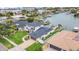 Aerial view of waterfront home with lush lawn, private dock, and access to bay at 330 Palm Ne Is, Clearwater Beach, FL 33767