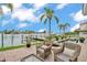 Backyard featuring wicker chairs, well maintained landscaping and waterfront views and boat dock at 330 Palm Ne Is, Clearwater Beach, FL 33767