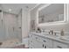 Elegant bathroom featuring a glass shower, vanity with double sinks, and a brightly lit mirror at 330 Palm Ne Is, Clearwater Beach, FL 33767