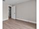 An empty bedroom with hardwood floors and an open doorway, offering a view into the bathroom at 330 Palm Ne Is, Clearwater Beach, FL 33767