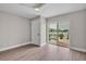 Bedroom with natural light, hardwood flooring, and a large sliding glass door overlooking the pool and dock at 330 Palm Ne Is, Clearwater Beach, FL 33767