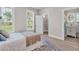 Bright bedroom featuring a large window, walk-in closet, and an en-suite bathroom at 330 Palm Ne Is, Clearwater Beach, FL 33767