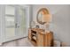 Stylish entryway featuring a wood cabinet, decor, a round mirror, and glass doors at 330 Palm Ne Is, Clearwater Beach, FL 33767