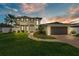 Stunning two-story home featuring lush landscaping, a walkway, and a spacious two-car garage at 330 Palm Ne Is, Clearwater Beach, FL 33767