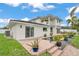 Exterior elevation view of the home with backyard pool, brick paved patio and manicured landscaping at 330 Palm Ne Is, Clearwater Beach, FL 33767