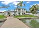 Exterior elevation of the home, with brick paved patio and waterfront views with personal dock at 330 Palm Ne Is, Clearwater Beach, FL 33767