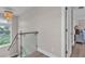 Bright upstairs hallway with glass railing, wood flooring, and stylish chandelier at 330 Palm Ne Is, Clearwater Beach, FL 33767