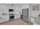 Modern kitchen features white cabinets, stainless appliances, and gas range cooktop at 330 Palm Ne Is, Clearwater Beach, FL 33767