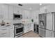 Modern kitchen design with stainless steel appliances, white cabinets, and sleek countertops at 330 Palm Ne Is, Clearwater Beach, FL 33767