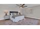 Comfortable main bedroom with wood flooring, ceiling fan, and designer lamps at 330 Palm Ne Is, Clearwater Beach, FL 33767