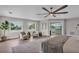 Bright main bedroom featuring a ceiling fan, water views, and balcony access at 330 Palm Ne Is, Clearwater Beach, FL 33767