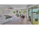 Comfortable main bedroom featuring a ceiling fan, water view, and balcony access at 330 Palm Ne Is, Clearwater Beach, FL 33767