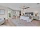Spacious main bedroom with wood flooring, sitting area, ceiling fan and balcony access at 330 Palm Ne Is, Clearwater Beach, FL 33767