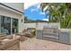 Outdoor kitchen with built in grill and seating area at 330 Palm Ne Is, Clearwater Beach, FL 33767