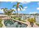 Backyard pool featuring a waterfront view, personal boat dock and mature palm trees at 330 Palm Ne Is, Clearwater Beach, FL 33767