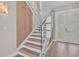 Modern staircase with glass railings and wood accents leading to the upper level at 330 Palm Ne Is, Clearwater Beach, FL 33767