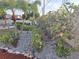 Landscaped backyard featuring a rock ground cover, tropical plants, and newly installed mulch along the perimeter at 3357 Hunt Club Dr, Clearwater, FL 33761