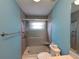Bathroom boasts a modern shower with sliding glass door, updated vanity, and calming blue walls at 3357 Hunt Club Dr, Clearwater, FL 33761