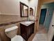 Bathroom features a granite countertop, dark wood vanity, decorative tile, and low-flow toilet at 3357 Hunt Club Dr, Clearwater, FL 33761