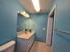 Bathroom boasts an updated vanity with a marble countertop, white cabinets, and modern fixtures at 3357 Hunt Club Dr, Clearwater, FL 33761