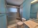 Bathroom showcases a modern shower with a sliding glass door, updated vanity, and calming blue walls at 3357 Hunt Club Dr, Clearwater, FL 33761