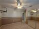Bedroom boasts neutral paint scheme, mirrored closets, tiled floor, and ceiling fan at 3357 Hunt Club Dr, Clearwater, FL 33761