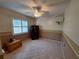 Bedroom boasts neutral paint scheme, tiled floor, closet, ceiling fan, and plantation shutters at 3357 Hunt Club Dr, Clearwater, FL 33761