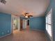 Bright bedroom featuring tile flooring, ceiling fan, and ensuite bathroom at 3357 Hunt Club Dr, Clearwater, FL 33761