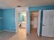 Bedroom boasts beautiful blue walls, an attached bathroom, and a spacious, organized closet at 3357 Hunt Club Dr, Clearwater, FL 33761